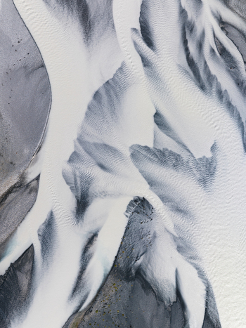 Aerial view of glacial rivers carve a stark abstract landscape of white and grey patterns across the terrain Lake Tekapo Canterbury Region New Zealand. Aerial view of glacial rivers carve a stark abstract landscape of white and grey patterns across the terrain Lake Tekapo Canterbury Region New Zealand.