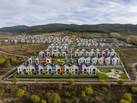 Aerial view of Residential Park Lozen featuring modern colorful townhouses with green lawns and paved streets in Sofia Sofia City Province Bulgaria. Aerial view of Residential Park Lozen featuring modern colorful townhouses with green lawns and paved streets in Sofia Sofia City Province Bulgaria.