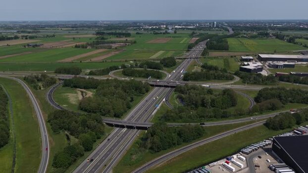 Aerial view of a highway interchange and green fields Netherlands.