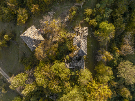 Aerial view of the abandoned stone ruins of Dyadovtsi surrounded by dense autumn forest with golden foliage in Dyadovtsi Kardzhali Province Bulgaria. Aerial view of the abandoned stone ruins of Dyadovtsi surrounded by dense autumn forest with golden foliage in Dyadovtsi Kardzhali Province Bulgaria.