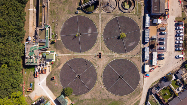 Sandhurst United Kingdom 21 September 2026 Aerial view of Sandhurst Sewage Treatment Works featuring four large circular sedimentation tanks industrial infrastructure and surrounding woodland. Sandhurst United Kingdom 21 September 2026 Aerial view of Sandhurst Sewage Treatment Works featuring four large circular sedimentation tanks industrial infrastructure and surrounding woodland.