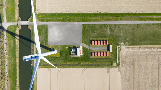 Aerial view of battery storage system at wind park with wind turbines