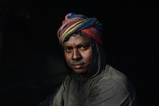 Kushtia District Khulna Division Bangladesh 28 November 2020 View of a man wearing a colorful turban and a dark hoodie looking directly at the camera. Kushtia District Khulna Division Bangladesh 28 November 2020 View of a man wearing a colorful turban and a dark hoodie looking directly at the camera.