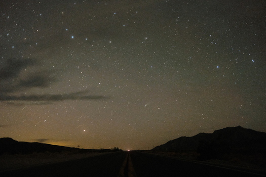 View of the starry night sky over a desert road with mountain silhouettes and the Big Dipper constellation Inyo County California United States. View of the starry night sky over a desert road with mountain silhouettes and the Big Dipper constellation Inyo County California United States.