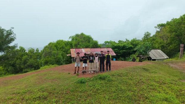 Aerial view of Bukit Pengilon with people and a rustic hut Indonesia. Aerial view of Bukit Pengilon with people and a rustic hut Indonesia.