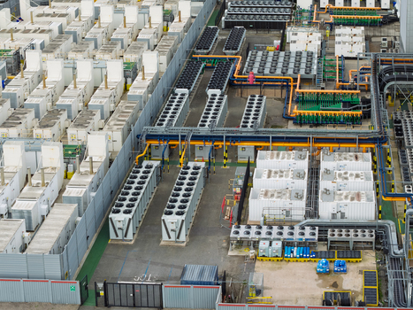 Aerial view of a data center with rows of cooling units industrial piping and server infrastructure in the United Kingdom.