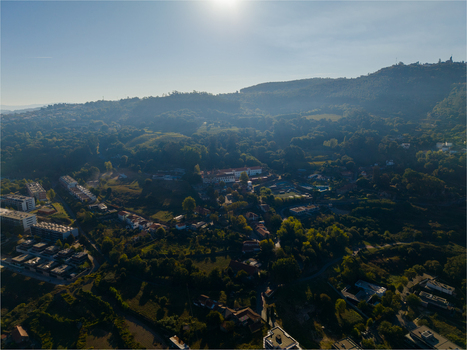 Aerial view of Pousada Mosteiro de Guimaraes nestled among the lush green hills and residential areas of Monte da Penha in Guimaraes Braga Portugal. Aerial view of Pousada Mosteiro de Guimaraes nestled among the lush green hills and residential areas of Monte da Penha in Guimaraes Braga Portugal.