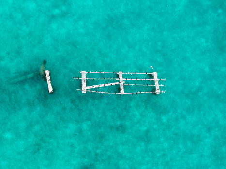 Aerial view of stark white structures and submerged remnants contrasting against vibrant turquoise waters Hoarafushi Thiladhunmathee Uthuruburi Maldives. Aerial view of stark white structures and submerged remnants contrasting against vibrant turquoise waters Hoarafushi Thiladhunmathee Uthuruburi Maldives.