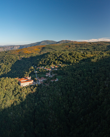 Aerial view of the Monastery of Santo Estevo de Ribas de Sil nestled within the lush green forests of the Ribeira Sacra region in O Covelo Ourense Spain.
