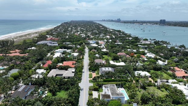 Aerial view of the town with its neat rows of houses bordered by the tranquil ocean and the bay Palm Beach Florida United States.