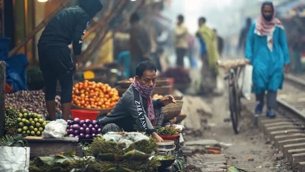 View of a street market next to railway tracks in Bogura Bangladesh. View of a street market next to railway tracks in Bogura Bangladesh.