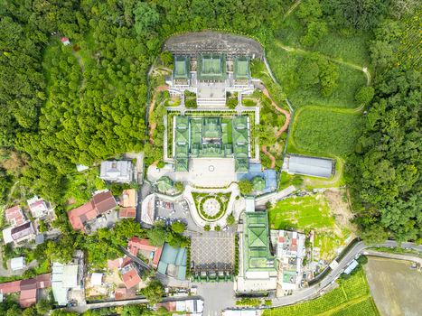 Aerial view of the Chung Tai Chan Monastery with its distinctive green tiled roofs symmetrical courtyards and surrounding lush forest in Puli Township Nantou County Taiwan. Aerial view of the Chung Tai Chan Monastery with its distinctive green tiled roofs symmetrical courtyards and surrounding lush forest in Puli Township Nantou County Taiwan.