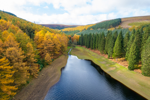 Aerial view of Ladybower Reservoir surrounded by vibrant autumn forests and rolling hills in Hope Valley England United Kingdom. Aerial view of Ladybower Reservoir surrounded by vibrant autumn forests and rolling hills in Hope Valley England United Kingdom.