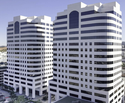 Aerial view of modern office towers with geometric lines and glass windows in Los Angeles California United States.