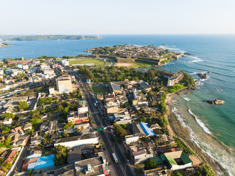 Aerial view of the historic Galle Fort on the peninsula overlooking the Indian Ocean with the cricket stadium and urban buildings Galle Southern Province Sri Lanka.