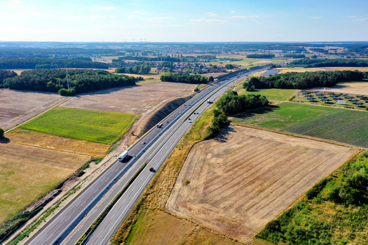 Nurnberg Germany 18 May 2024 Aerial view of the A73 motorway stretching through a patchwork of agricultural fields and lush green forests under a clear blue sky. Nurnberg Germany 18 May 2024 Aerial view of the A73 motorway stretching through a patchwork of agricultural fields and lush green forests under a clear blue sky.