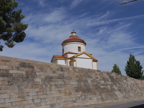View of the historic Capela do Calvario with its white walls and terracotta dome rising above a massive stone fortification wall Portalegre Portalegre Portugal. View of the historic Capela do Calvario with its white walls and terracotta dome rising above a massive stone fortification wall Portalegre Portalegre Portugal.
