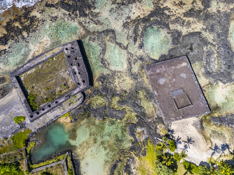 Aerial view of the ancient stone heiau structures at Kahalu u Beach Park surrounded by turquoise tide pools and dark volcanic lava rock in Kailua Kona Hawaii United States. Aerial view of the ancient stone heiau structures at Kahalu u Beach Park surrounded by turquoise tide pools and dark volcanic lava rock in Kailua Kona Hawaii United States.