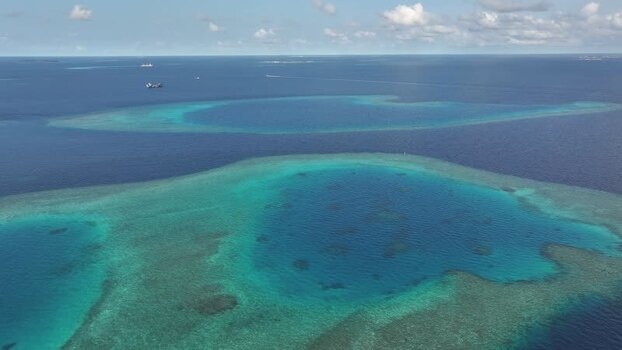 Aerial view of turquoise coral reefs and deep blue ocean waters Maldives. Aerial view of turquoise coral reefs and deep blue ocean waters Maldives.