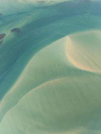 Aerial view of turquoise waters swirl around sandy shores creating a mesmerizing dance of color and texture Iceland Iceland. Aerial view of turquoise waters swirl around sandy shores creating a mesmerizing dance of color and texture Iceland Iceland.