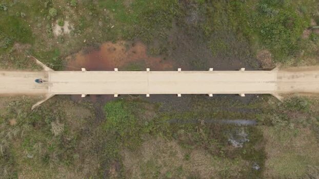 Aerial view of a cyclist crossing a bridge in Greyton South Africa. Aerial view of a cyclist crossing a bridge in Greyton South Africa.