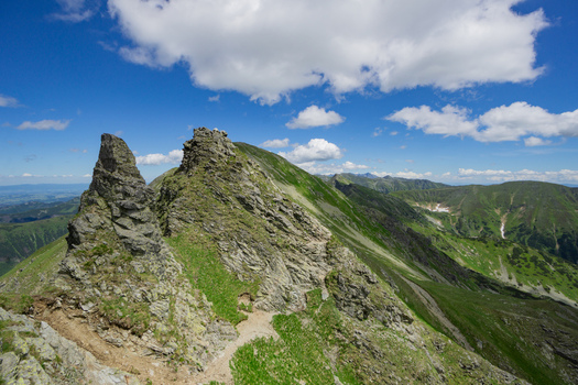 View of Tri kopy in Western Tatras with sharp rocky peaks and green mountain slopes under a blue sky in Ziar Zilina Region Slovakia. View of Tri kopy in Western Tatras with sharp rocky peaks and green mountain slopes under a blue sky in Ziar Zilina Region Slovakia.