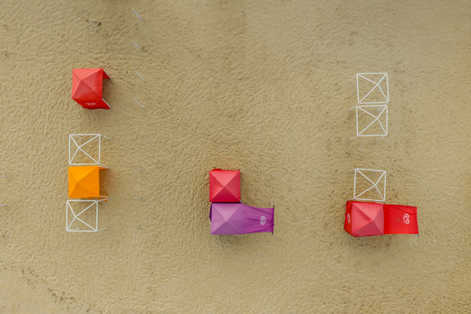 Aerial view of colorful beach tents and white gazebo frames on the golden sand of Praia de Sao Pedro de Moel in Marinha Grande Leiria Portugal. Aerial view of colorful beach tents and white gazebo frames on the golden sand of Praia de Sao Pedro de Moel in Marinha Grande Leiria Portugal.