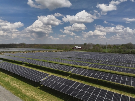 Lebanon United States 12 April 2026 Aerial view of a large solar farm with rows of photovoltaic panels on green grass under a blue sky with white clouds.