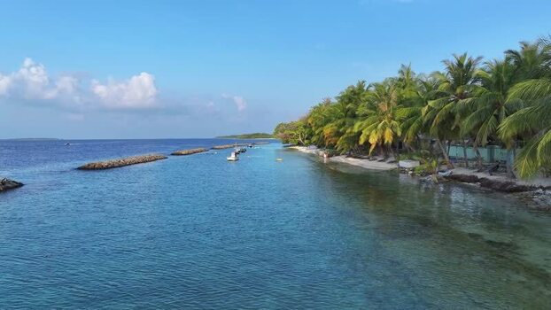 Aerial view of tropical coastline and palm trees in Kendhoo Maldives. Aerial view of tropical coastline and palm trees in Kendhoo Maldives.