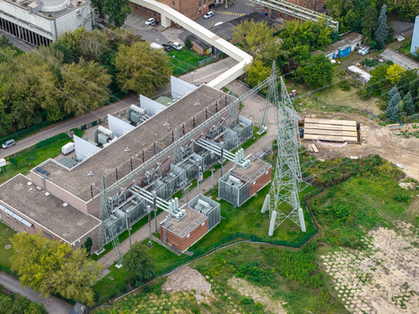 Aerial view of Umspannwerk Reuter electrical substation featuring industrial power equipment metal transmission towers and surrounding greenery in Berlin Berlin Germany.