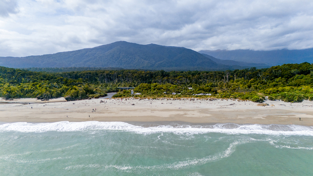 Aerial view of the rugged coastline meeting the lush forest under a cloudy sky near Haast Highway Ship Creek Haast West Coast Region New Zealand. Aerial view of the rugged coastline meeting the lush forest under a cloudy sky near Haast Highway Ship Creek Haast West Coast Region New Zealand.