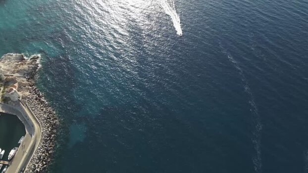 Aerial View of a boat sailing in Capo d Enfola Elba Island Tuscany Italy.