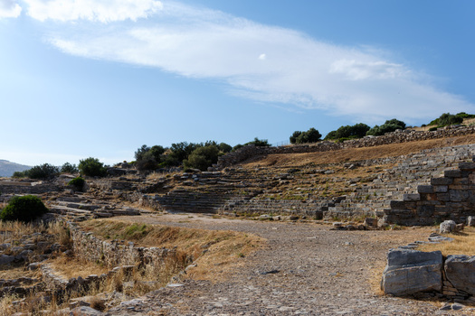 View of the ancient stone seating and ruins of the Ancient Theatre of Thorikos under a blue sky with light clouds in Thoricus Greece.