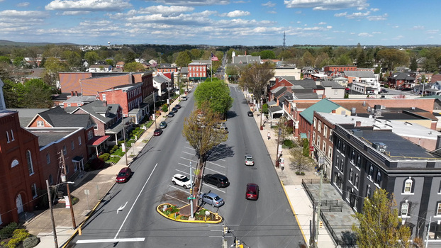 Aerial view of the historic town center of Manheim with brick buildings tree lined streets and cars parked along the road in Manheim Pennsylvania United States.