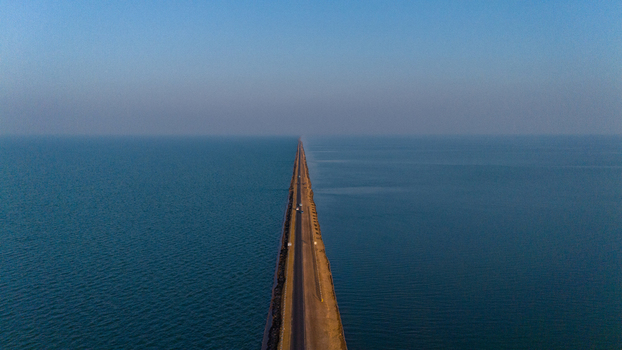 Aerial view of the Road to Heaven a long straight road stretching through the calm blue waters of the Rann of Kutch in Bhuj Gujarat India. Aerial view of the Road to Heaven a long straight road stretching through the calm blue waters of the Rann of Kutch in Bhuj Gujarat India.