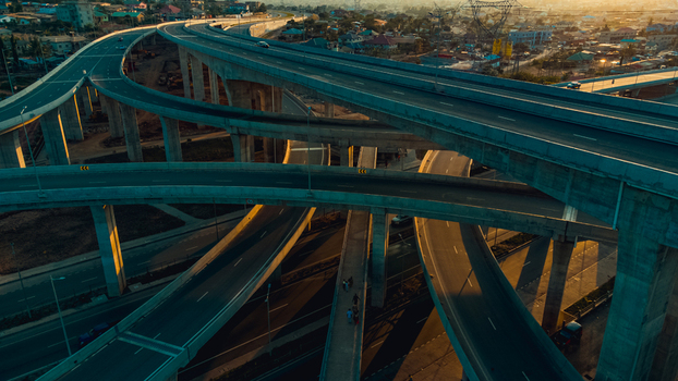 Aerial view of the Pokuase interchange featuring multi level concrete flyovers and roads illuminated by the warm golden hour light in Ga North Municipal Greater Accra Region Ghana. Aerial view of the Pokuase interchange featuring multi level concrete flyovers and roads illuminated by the warm golden hour light in Ga North Municipal Greater Accra Region Ghana.