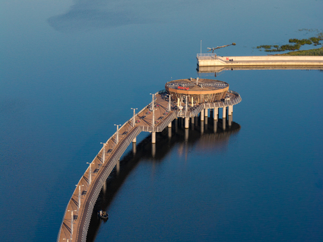 Aerial view of the modern pier and marina extending into the calm blue waters of the Vistula River in Plock Masovian Voivodeship Poland.