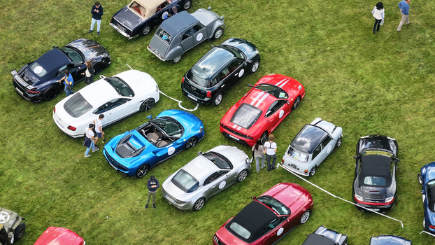 La Chapelle de Guinchay France 01 June 2024 Aerial view of luxury and classic cars parked on a green lawn during an outdoor exhibition with people walking around. La Chapelle de Guinchay France 01 June 2024 Aerial view of luxury and classic cars parked on a green lawn during an outdoor exhibition with people walking around.