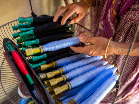 Joypurhat Bangladesh 22 September 2026 View of a person s hands preparing bobbins with blue and black thread for traditional textile weaving. Joypurhat Bangladesh 22 September 2026 View of a person s hands preparing bobbins with blue and black thread for traditional textile weaving.