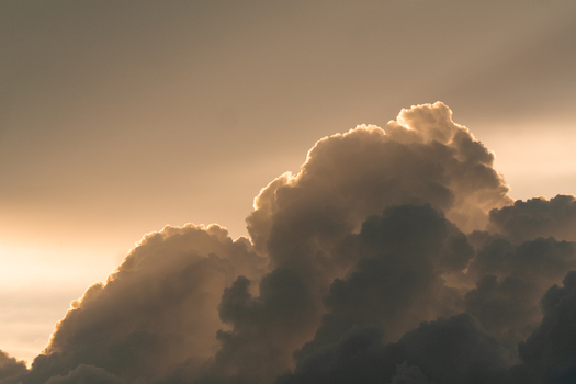 View of golden hour clouds illuminated by the setting sun in the sky over Costa Rica.