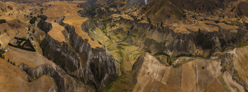 Aerial view of Toachi River Canyon with deep rocky gorges winding river and golden agricultural fields in Zumbahua Cotopaxi Ecuador. Aerial view of Toachi River Canyon with deep rocky gorges winding river and golden agricultural fields in Zumbahua Cotopaxi Ecuador.