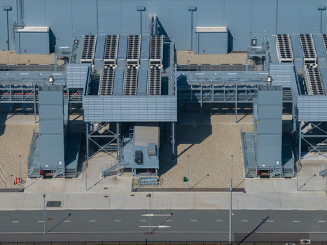 Aerial view of a modern datacenter with industrial cooling units and infrastructure in The Netherlands. Aerial view of a modern datacenter with industrial cooling units and infrastructure in The Netherlands.