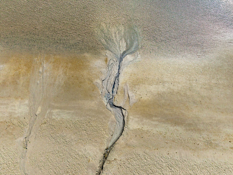 Aerial view of the intricate tidal channels and sand patterns of the Baie de Somme at low tide showcasing natural textures in Saint Valery sur Somme Hauts de France France. Aerial view of the intricate tidal channels and sand patterns of the Baie de Somme at low tide showcasing natural textures in Saint Valery sur Somme Hauts de France France.