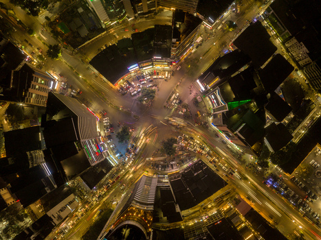 Aerial view of the city center s vibrant roundabout where bright lights blur into streaks of gold amid dark buildings Dhaka Dhaka Division Bangladesh. Aerial view of the city center s vibrant roundabout where bright lights blur into streaks of gold amid dark buildings Dhaka Dhaka Division Bangladesh.