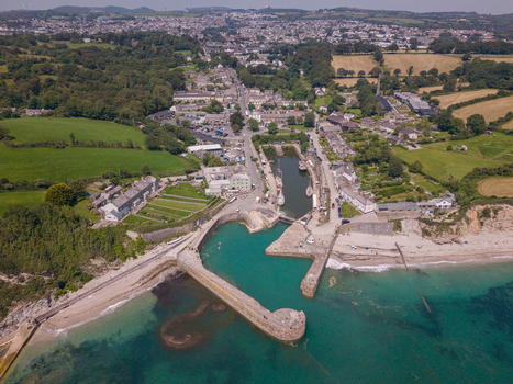 Aerial view of Charlestown Harbour with its historic stone piers turquoise water and surrounding village buildings nestled in the coastal landscape of Charlestown Cornwall United Kingdom. Aerial view of Charlestown Harbour with its historic stone piers turquoise water and surrounding village buildings nestled in the coastal landscape of Charlestown Cornwall United Kingdom.