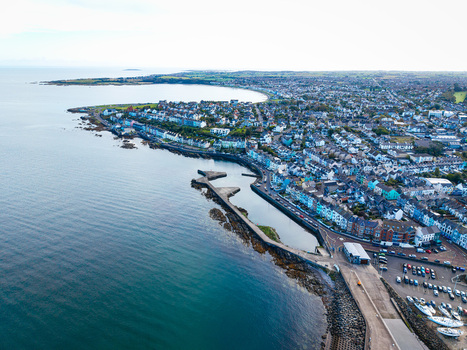 Aerial view of Bangor Harbour and Town with colorful buildings coastal promenade and boats docked in the marina in Bangor Northern Ireland United Kingdom.