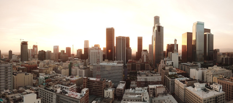 Aerial view of the Los Angeles skyline featuring modern skyscrapers and urban architecture at sunset in Los Angeles California United States.