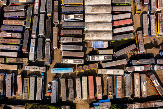 Aerial view of Gabtoli Bus Terminal with rows of parked buses on the concrete lot in Dhaka Dhaka Division Bangladesh.