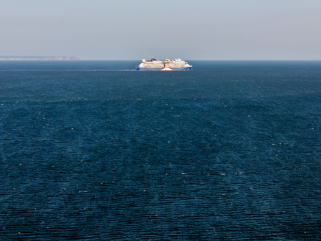 Aerial view of a large cruise ship sailing on the deep blue Atlantic Ocean off the coast Lisboa Portugal.