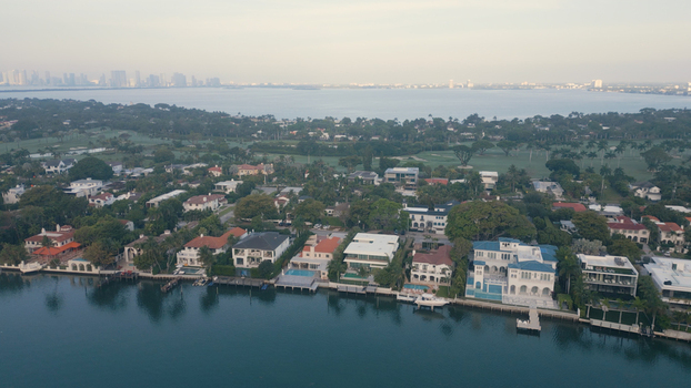 Aerial view of luxury waterfront homes with private docks and swimming pools along the coast of Miami Beach Florida United States. Aerial view of luxury waterfront homes with private docks and swimming pools along the coast of Miami Beach Florida United States.